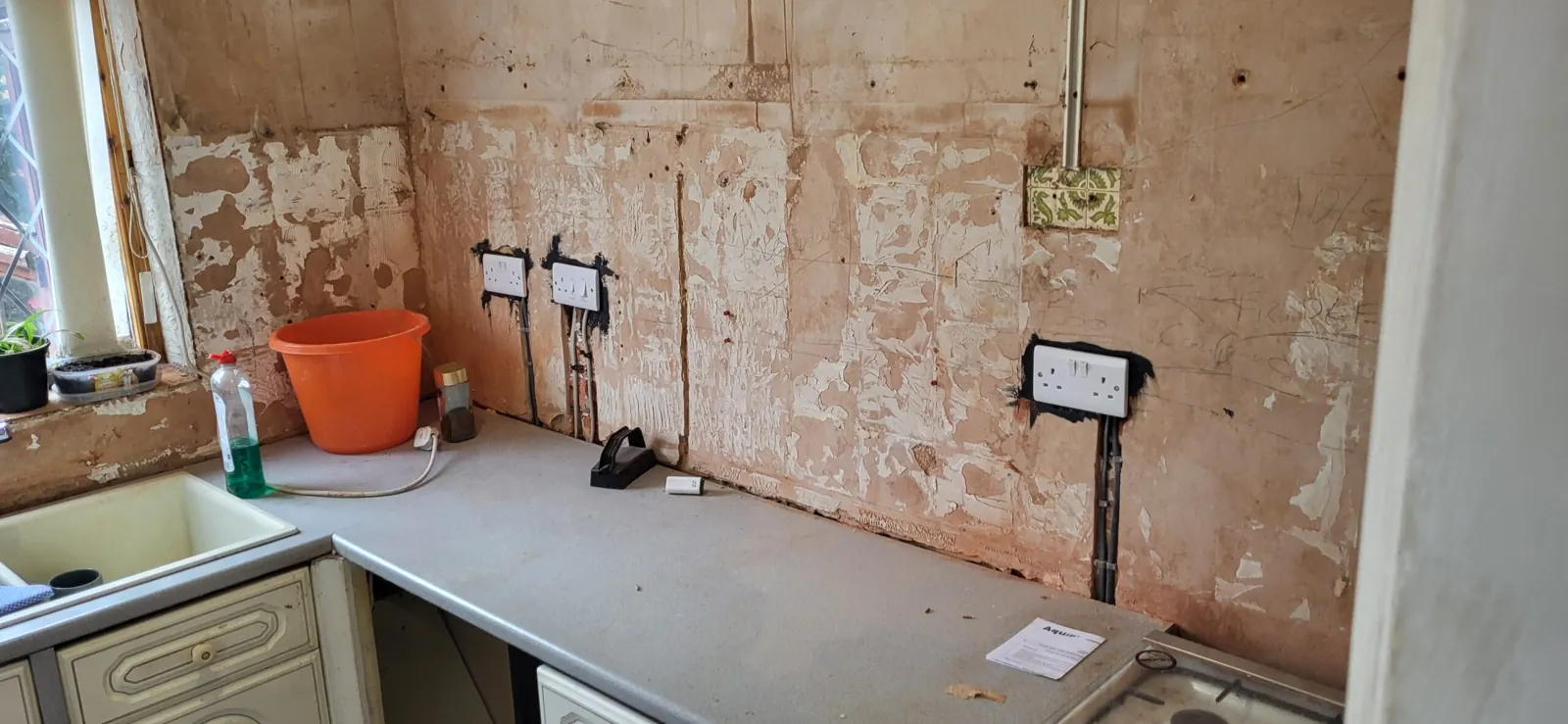 Sockets and cabling exposed during electrical works in a Cheshire kitchen