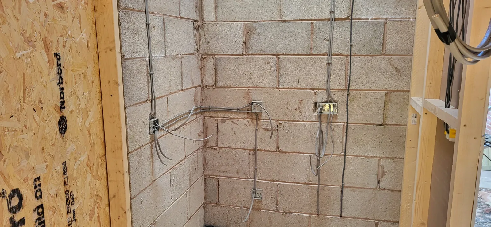 Electrical first fix wiring and back boxes inspected on blockwork walls